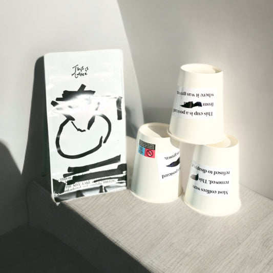 DR Congo Kivu Mutendero coffee bag placed along with THISISnotCOFFEE paper cups