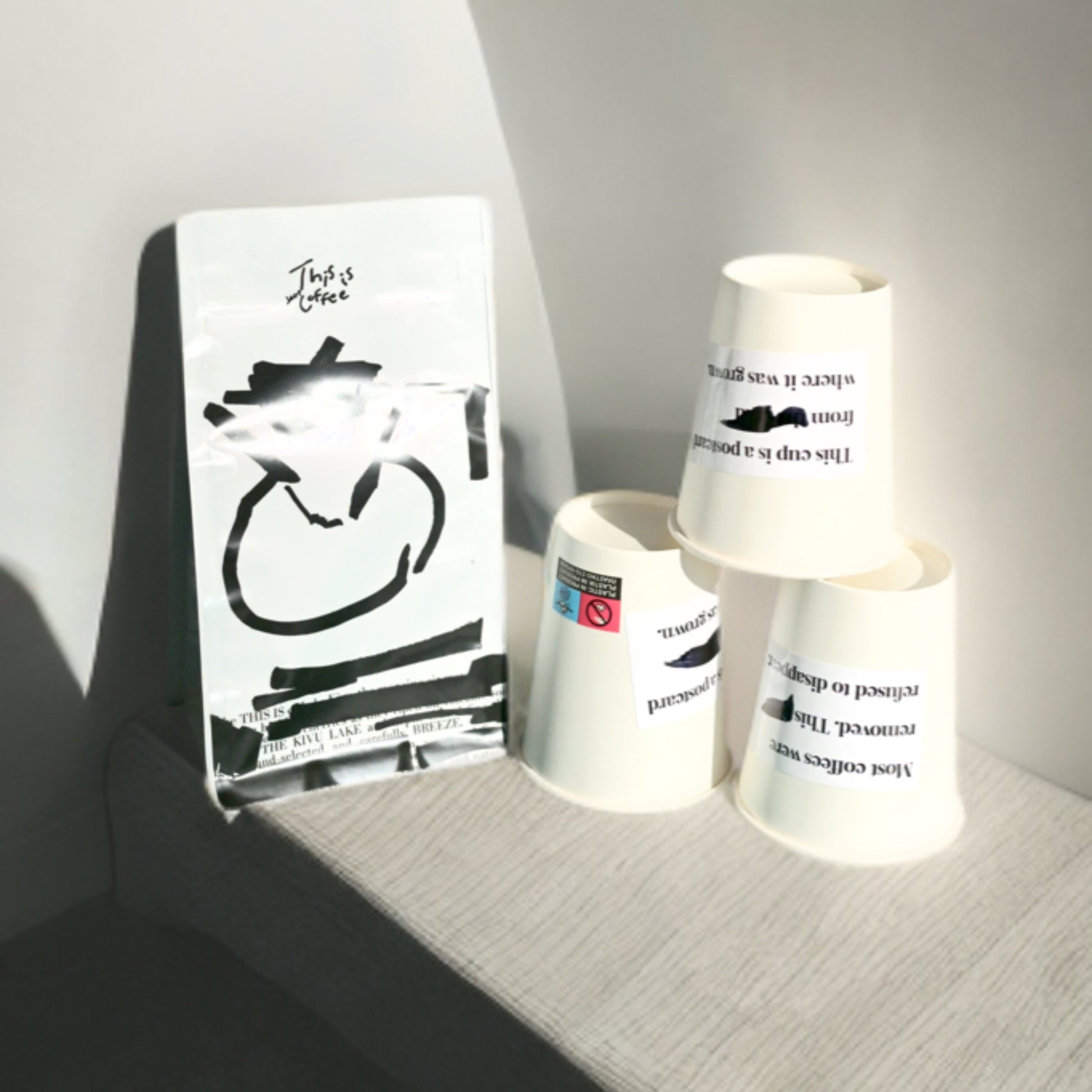 DR Congo Kivu Mutendero coffee bag placed along with THISISnotCOFFEE paper cups