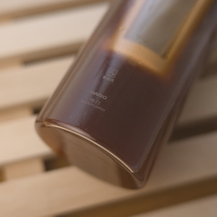 Close-up of Hario Filter-In Bottle for Cold Brew with silicone lid and glass body